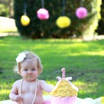 Baby girl with yellow icing cake
