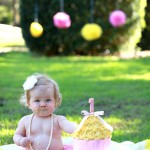 Baby girl with yellow icing cake