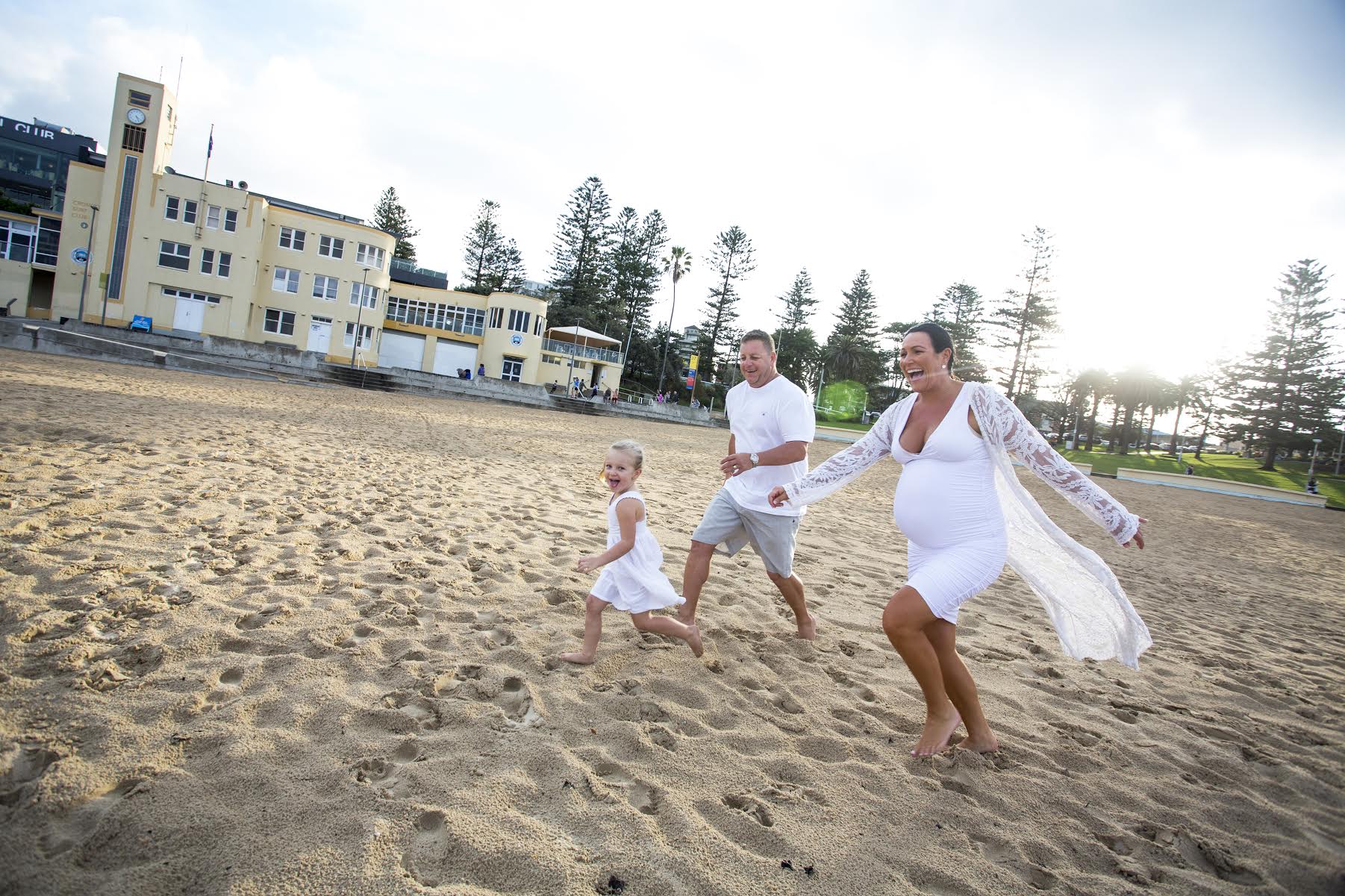 Family running on beach