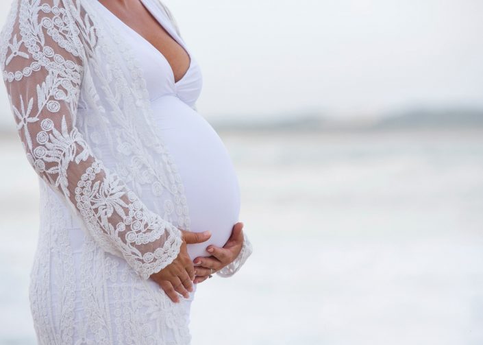 Lady in white holding pregnant belly - Shannon Elise Photography