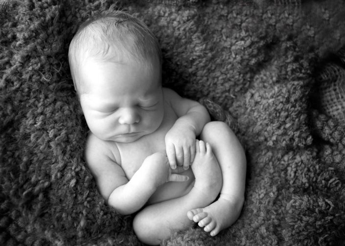 Newborn baby on woollen rug - Shannon Elise Photography