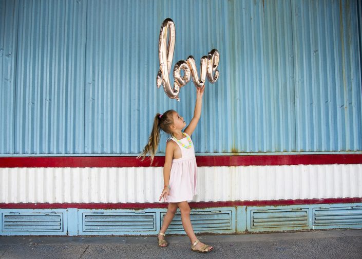 Child Holding Love Balloon