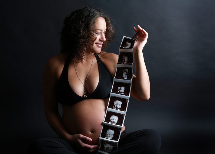 Pregnant Woman Holding Ultrasound Photos