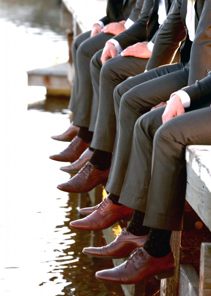 groomsmen sitting on dock