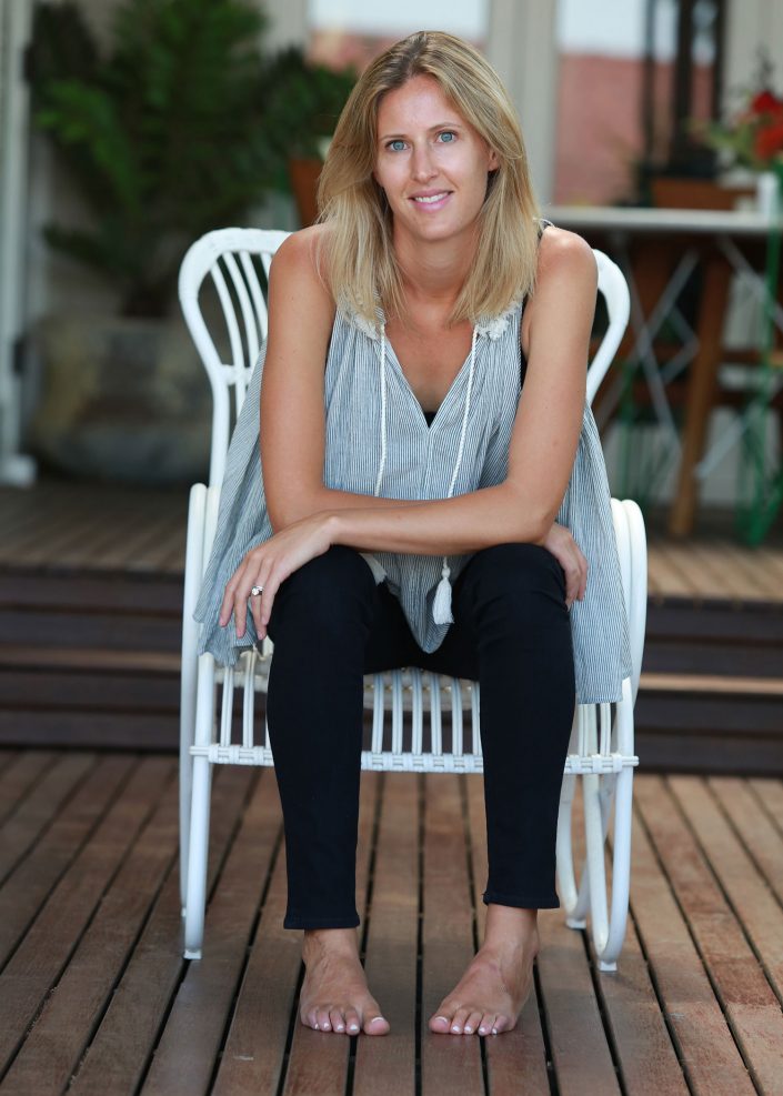 lady sitting on white wicker chair